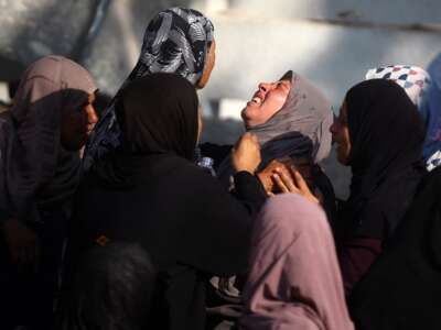 Palestinian women mourn a relative killed in an Israeli strike, at Al-Shifa Hospital in Gaza City, on July 15, 2025.