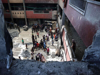 Top view of a destroyed school building that is now being used for shelter.