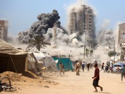 A thick column of smoke rises from Mushtaha Tower as it is destroyed in an Israeli airstrike in Gaza City, on September 5, 2025.