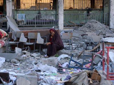 A Palestinian woman reacts as she checks the rubble of a school building destroyed in an Israeli strike in Gaza City the previous day, on September 10, 2025.