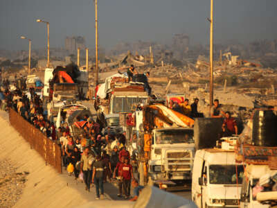 Displaced Palestinians move with their belongings southwards on a road in the Nuseirat refugee camp area in the central Gaza Strip on September 24, 2025, as Israel presses its air and ground offensive to capture Gaza City.