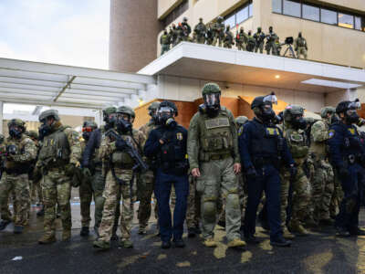 Federal agents clash with anti-ICE protesters at the U.S. Immigration and Customs Enforcement building on October 12, 2025, in Portland, Oregon.