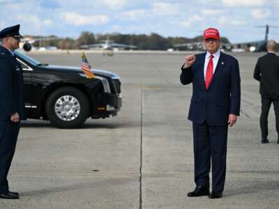 President Donald Trump gestures to the press upon arrival at Joint Base Andrews in Maryland, on October 30, 2025.