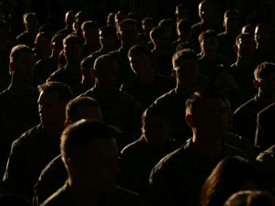 Members of the military listen as First Lady Melania Trump gives remarks during her visit to Marine Corps Air Station New River in Jacksonville, North Carolina, November 19, 2025.