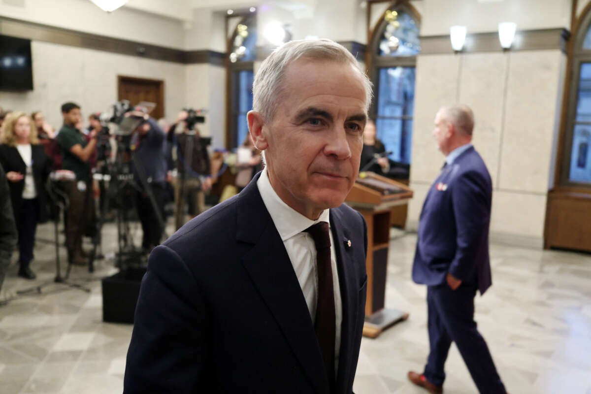 Canadian Prime Minister Mark Carney leaves after speaking with reporters about new measures to protect Canadian strategic industries in Parliament Hill, Ottawa, Ontario, Canada, on November 26, 2025.