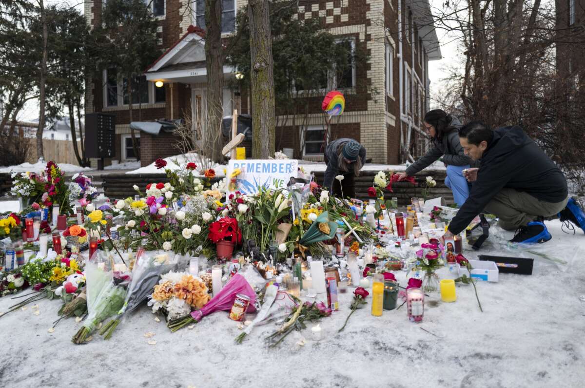 People tend to a memorial for Renee Nicole Good near the site of her shooting, on January 8, 2026, in Minneapolis, Minnesota.