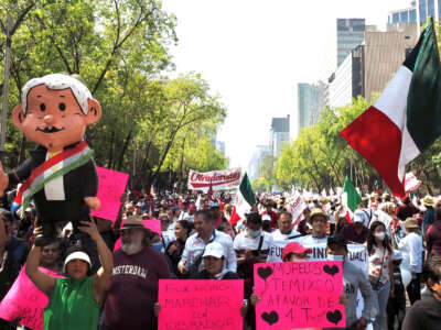 A crowd of supporters of Mexican President Andrés Manuel López Obrador march down Mexico City’s Paseo de la Reforma during a demonstration to celebrate his government’s accomplishments in the four years since the start of his presidency, November 27, 2022.