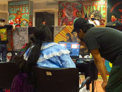 Armando Gómez (center-left, in black) works with other Otomí activists to record a meeting.