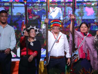 CONAIE’S new president, Marlon Vargas, holds a symbolic spear on stage during his inauguration in the Amazonian city of Puyo, Pastaza, Ecuador, on August 9, 2025.