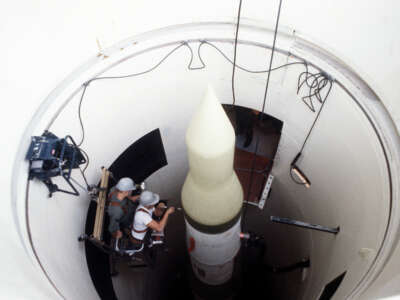 Two missile maintenance crewmen perform an electrical check on an LGM-30F Minuteman II intercontinental ballistic missile (ICBM) in its silo at Whiteman Air Force Base, Missouri.